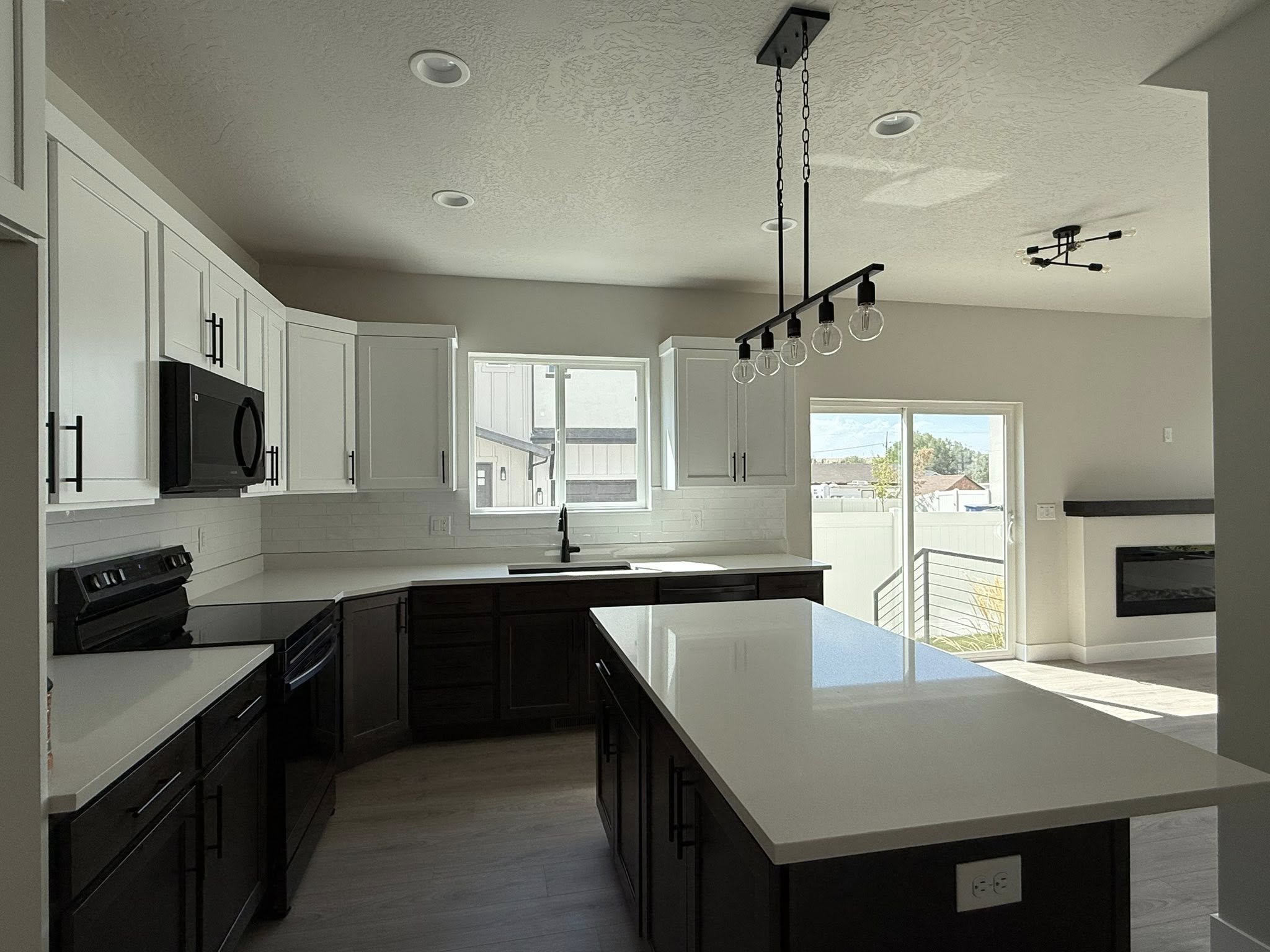 Spotless kitchen with white countertops and dark cabinets after deep clean