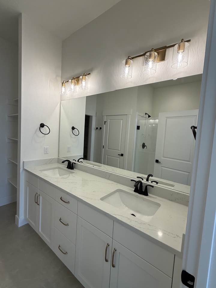 Sparkling double-sink bathroom vanity with marble countertop after sanitizing